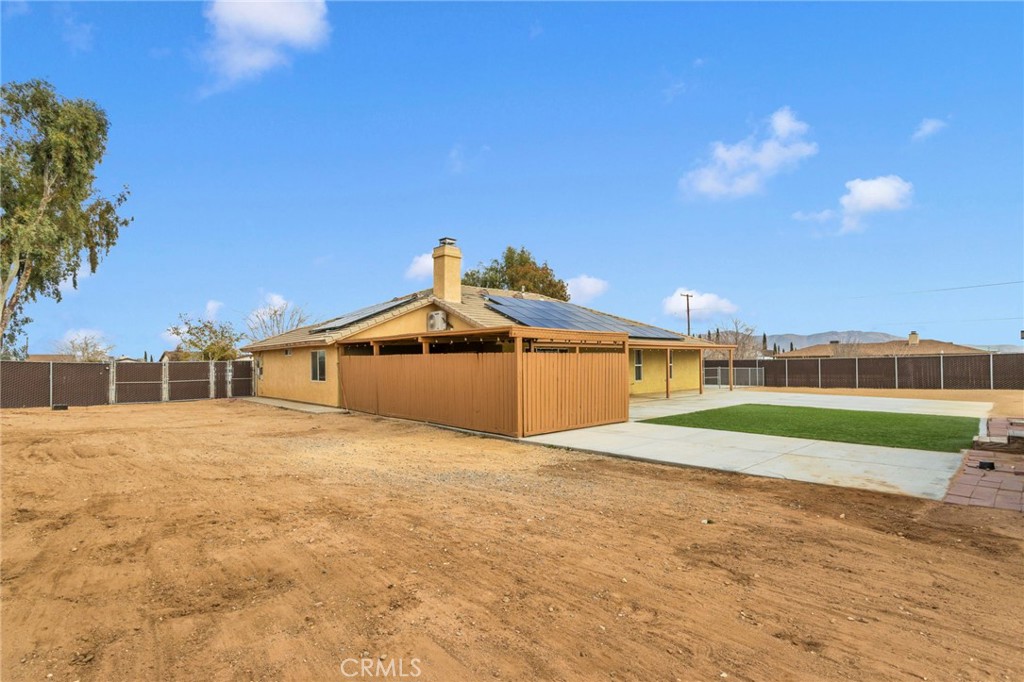 11410 Cibola Road Apple Valley, CA 92308 - Photo 39 of 45 a front view of a house with a yard and garage