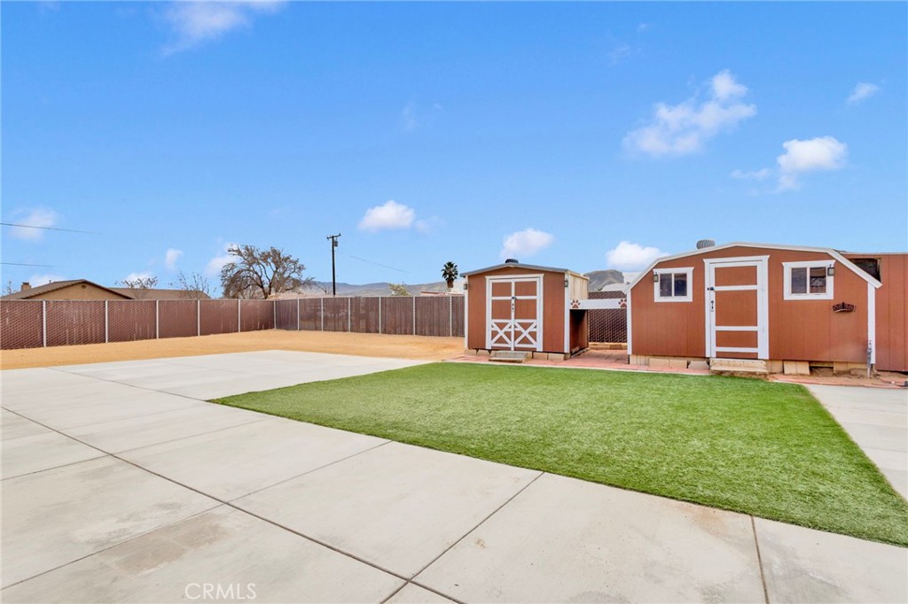 11410 Cibola Road Apple Valley, CA 92308 - Photo 40 of 45 a front view of a house with a garden
