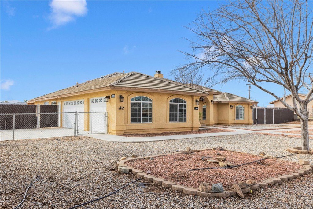 11410 Cibola Road Apple Valley, CA 92308 - Photo 4 of 45 a front view of a house with a yard