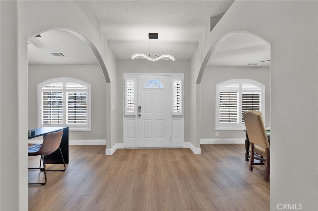 11410 Cibola Road Apple Valley, CA 92308 - Photo 6 of 45 wooden floor in an empty room with a window