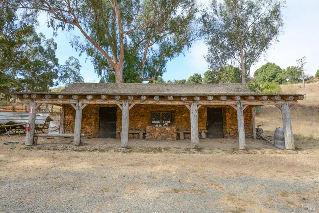 a view of a small house with backyard