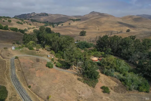 an aerial view of a houses with a yard