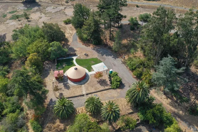 an aerial view of a house with a yard
