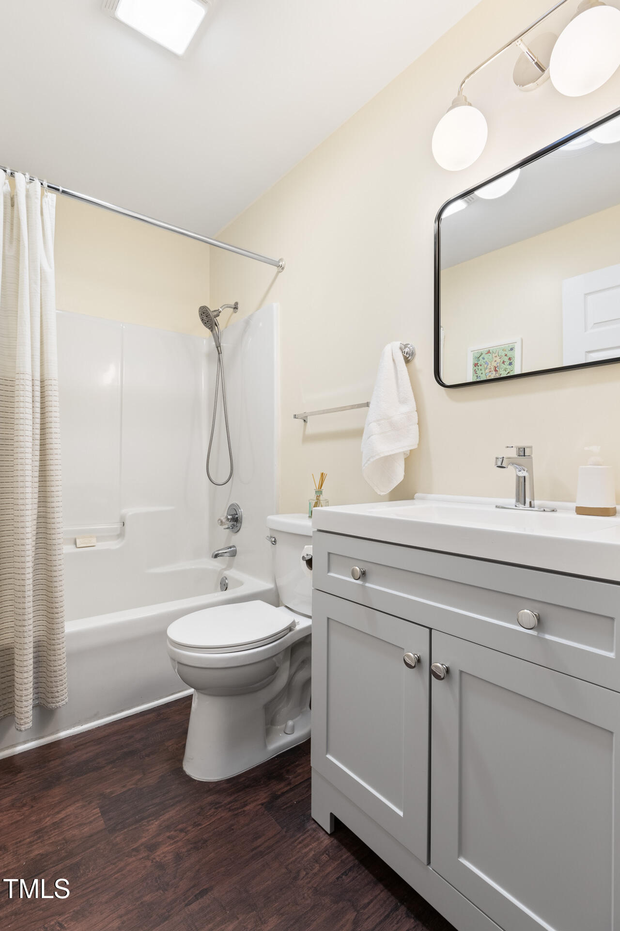 1234 Berkeley Street Durham, NC 27705 - Photo 17 of 46 a bathroom with a sink a toilet and shower a mirror