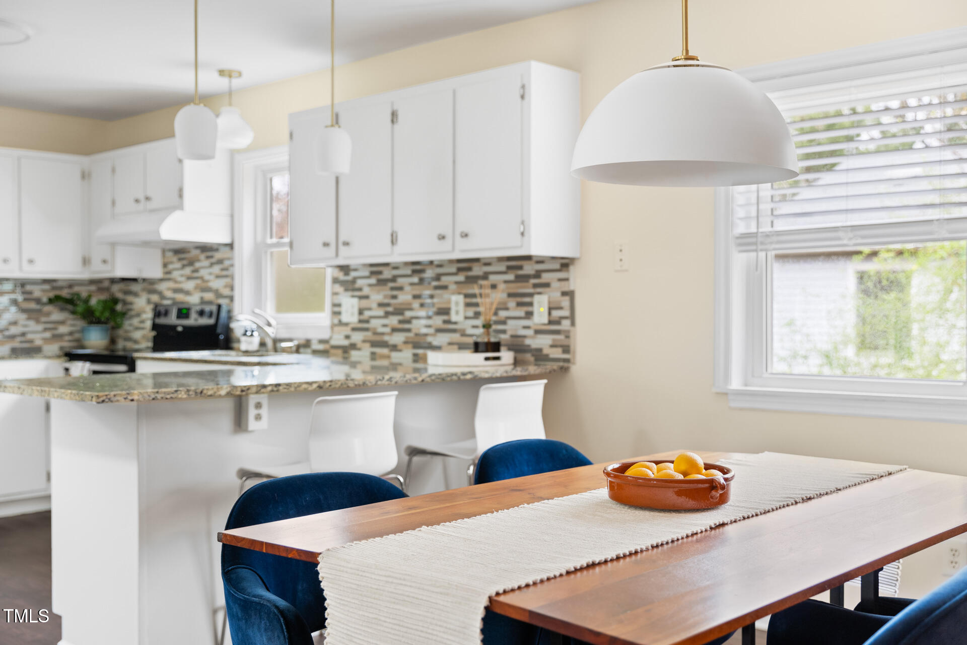 1234 Berkeley Street Durham, NC 27705 - Photo 25 of 46 a kitchen with stainless steel appliances granite countertop a sink a stove and a wooden floors