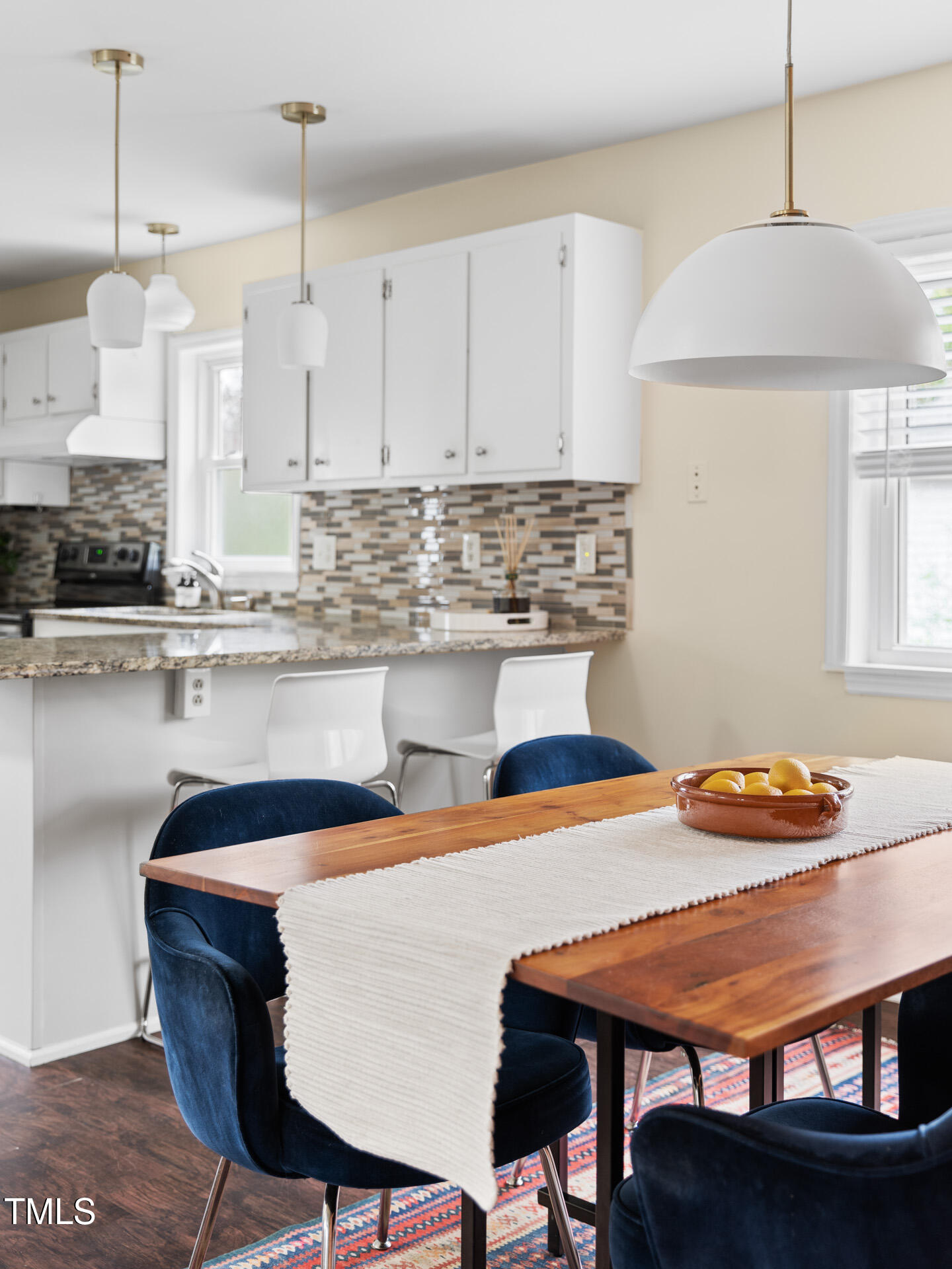 1234 Berkeley Street Durham, NC 27705 - Photo 26 of 46 a kitchen with stainless steel appliances granite countertop a stove a sink and a refrigerator