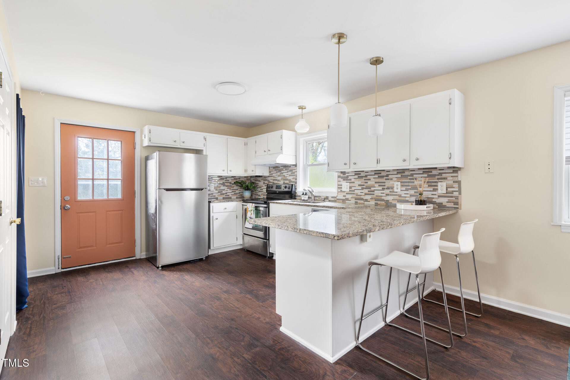 1234 Berkeley Street Durham, NC 27705 - Photo 27 of 46 a kitchen with stainless steel appliances white cabinets and wooden floor