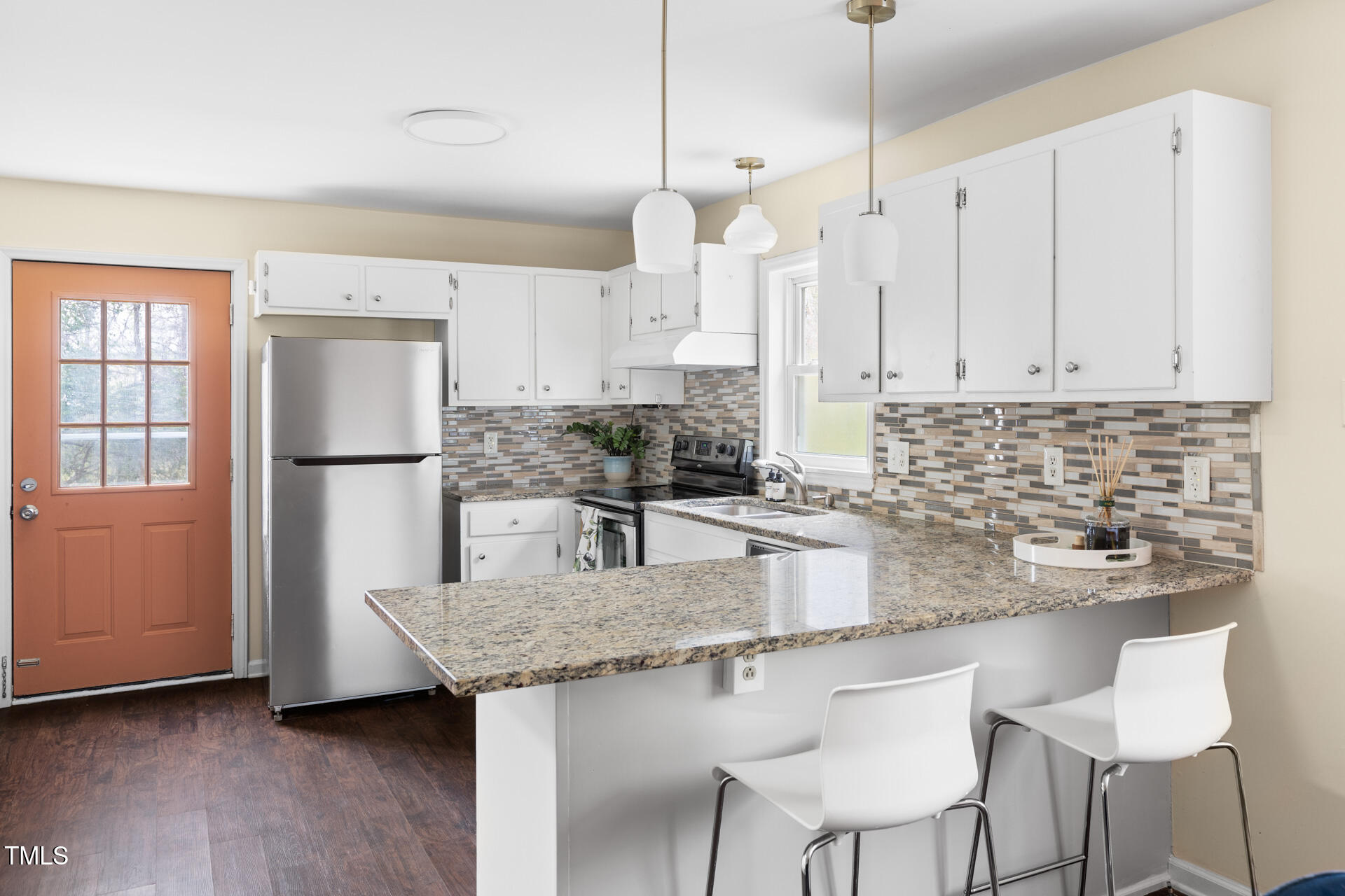 1234 Berkeley Street Durham, NC 27705 - Photo 29 of 46 a kitchen with stainless steel appliances granite countertop a sink a stove a refrigerator a center island and cabinets