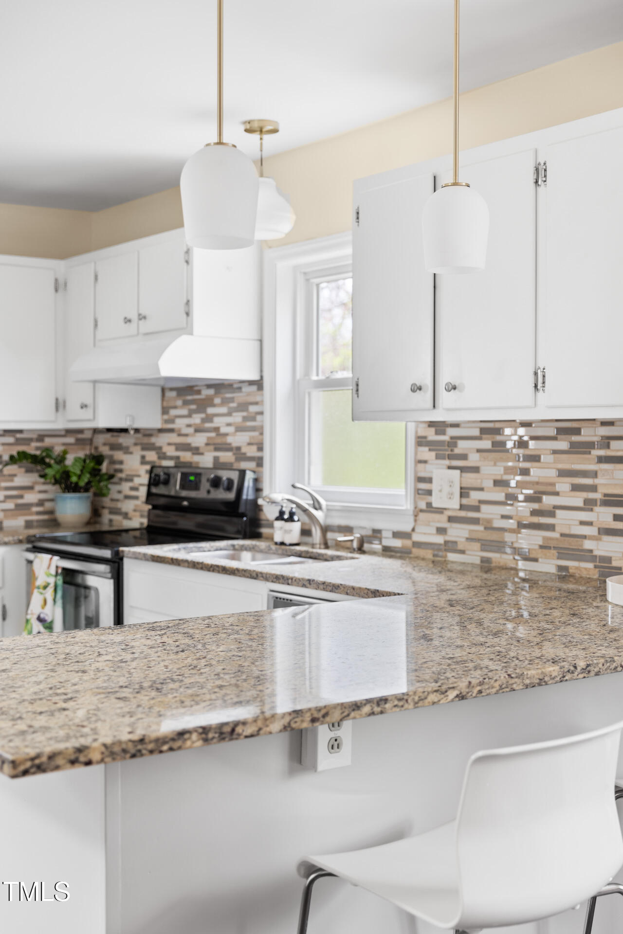 1234 Berkeley Street Durham, NC 27705 - Photo 31 of 46 a kitchen with granite countertop a sink a stove and cabinets