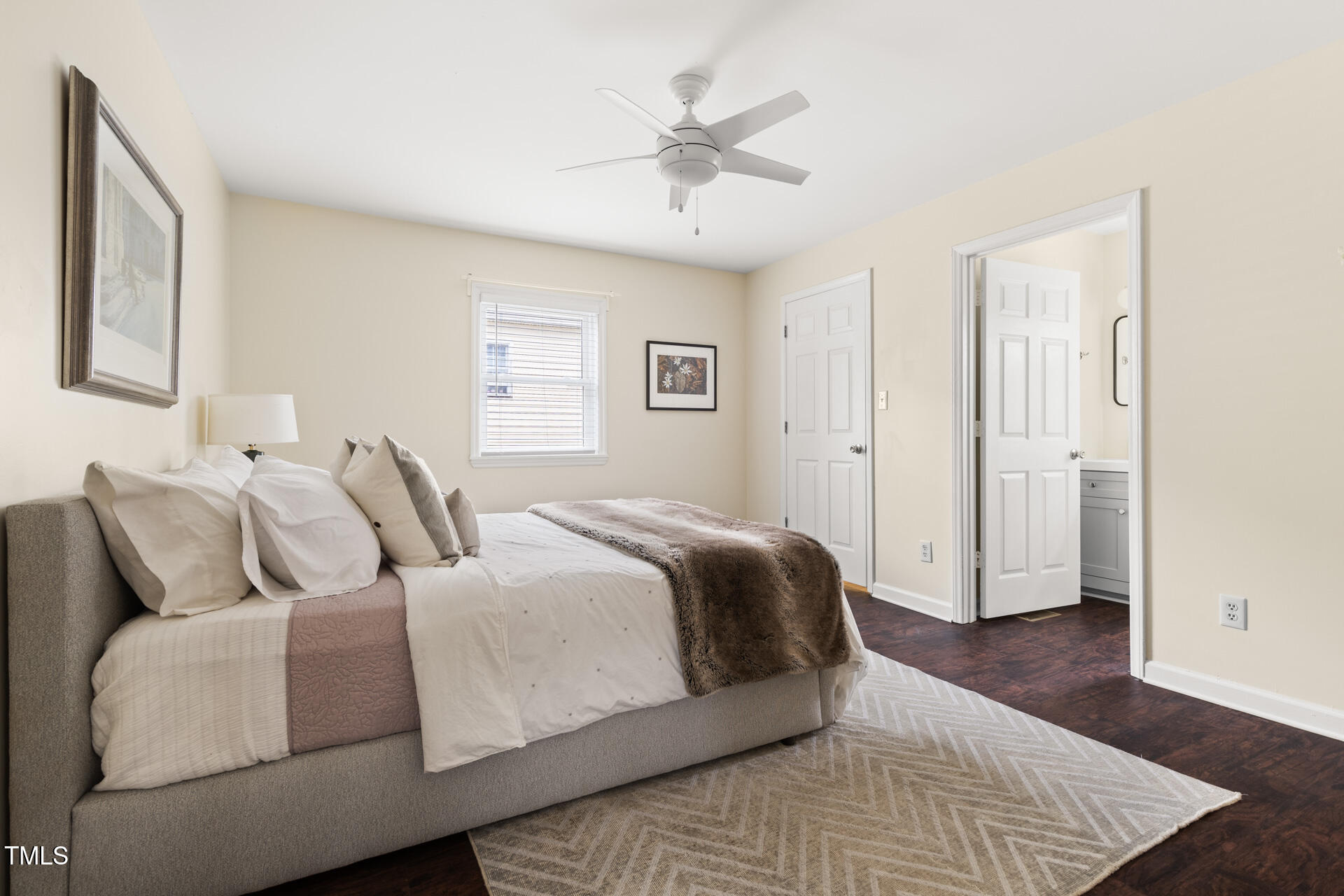 1234 Berkeley Street Durham, NC 27705 - Photo 34 of 46 a spacious bedroom with a bed and wooden floor