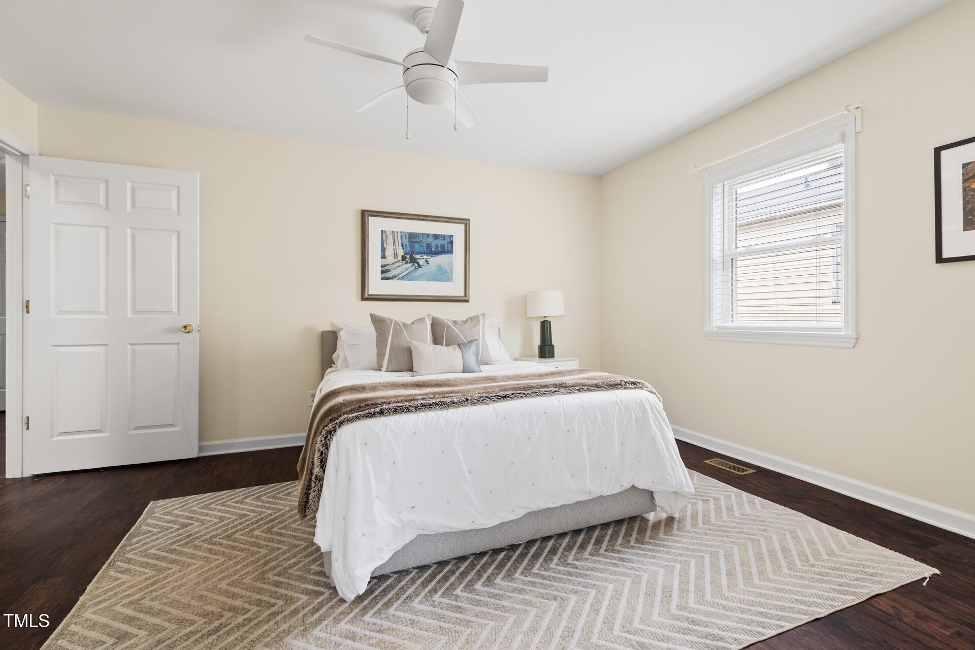 1234 Berkeley Street Durham, NC 27705 - Photo 35 of 46 a bedroom with a bed and wooden floor