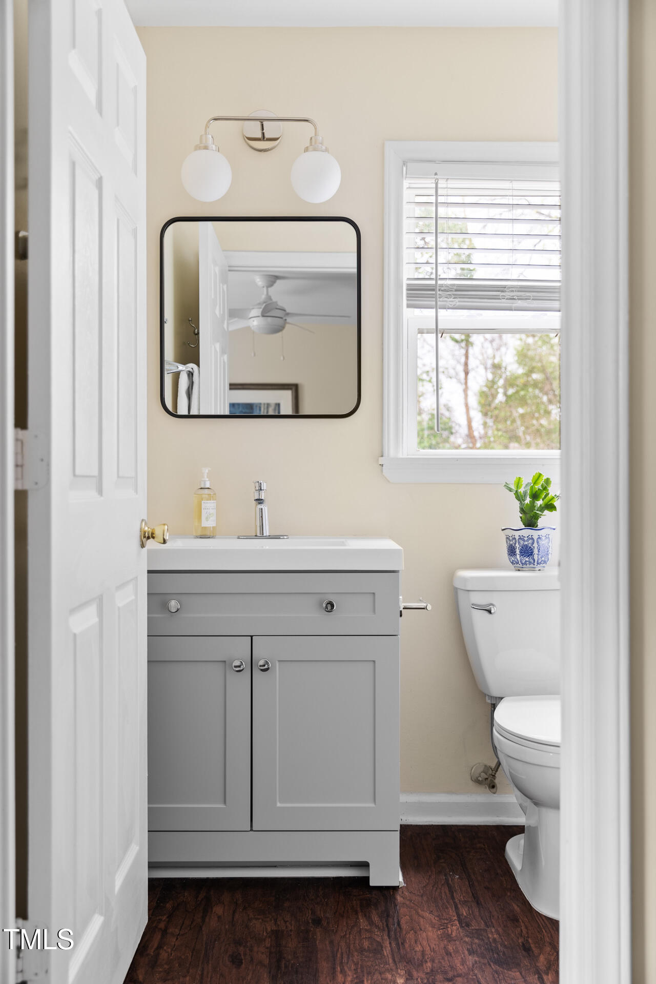 1234 Berkeley Street Durham, NC 27705 - Photo 38 of 46 a bathroom with a toilet a sink a vanity and mirror