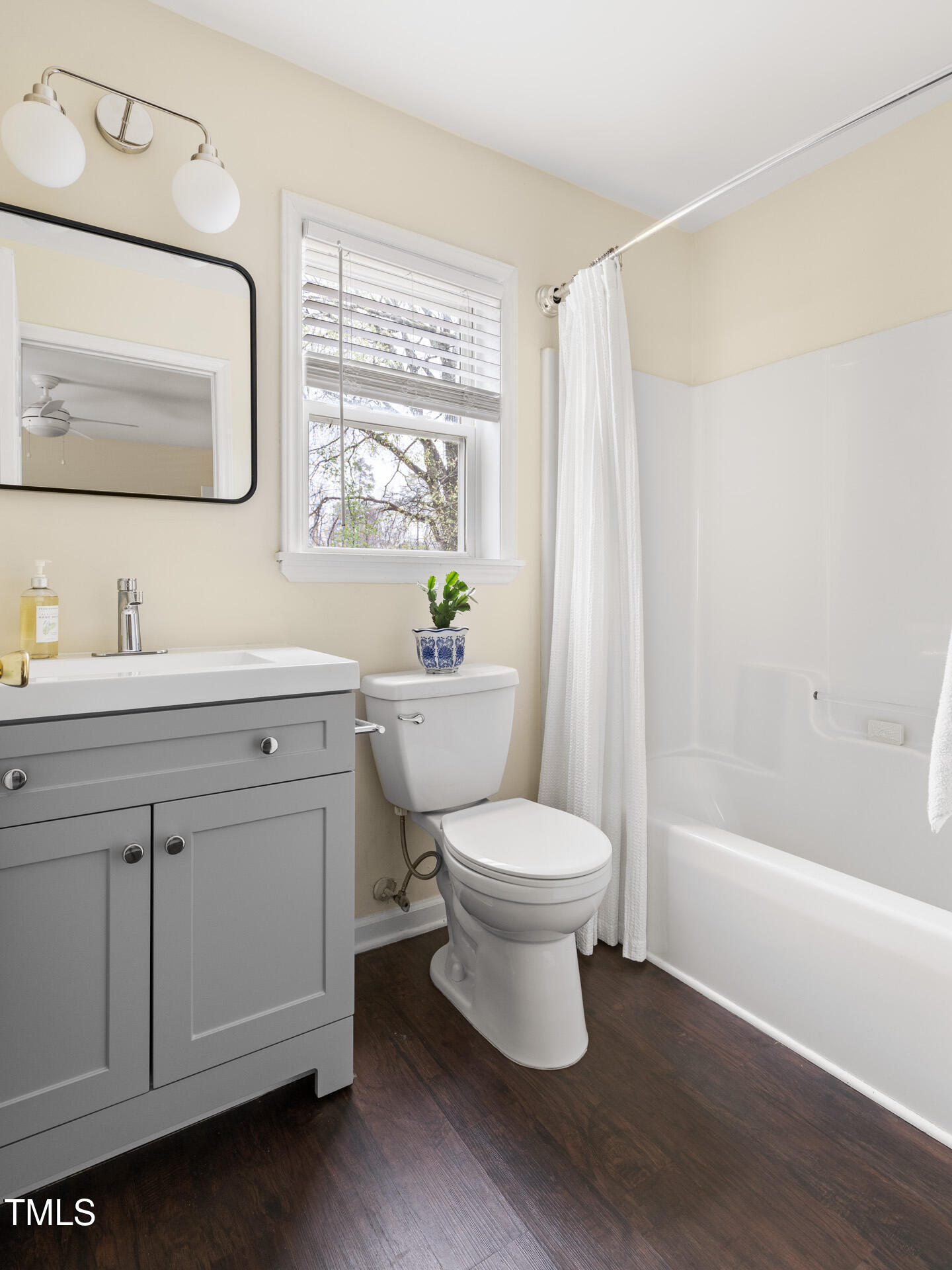 1234 Berkeley Street Durham, NC 27705 - Photo 40 of 46 a bathroom with a toilet sink a mirror and a bathtub