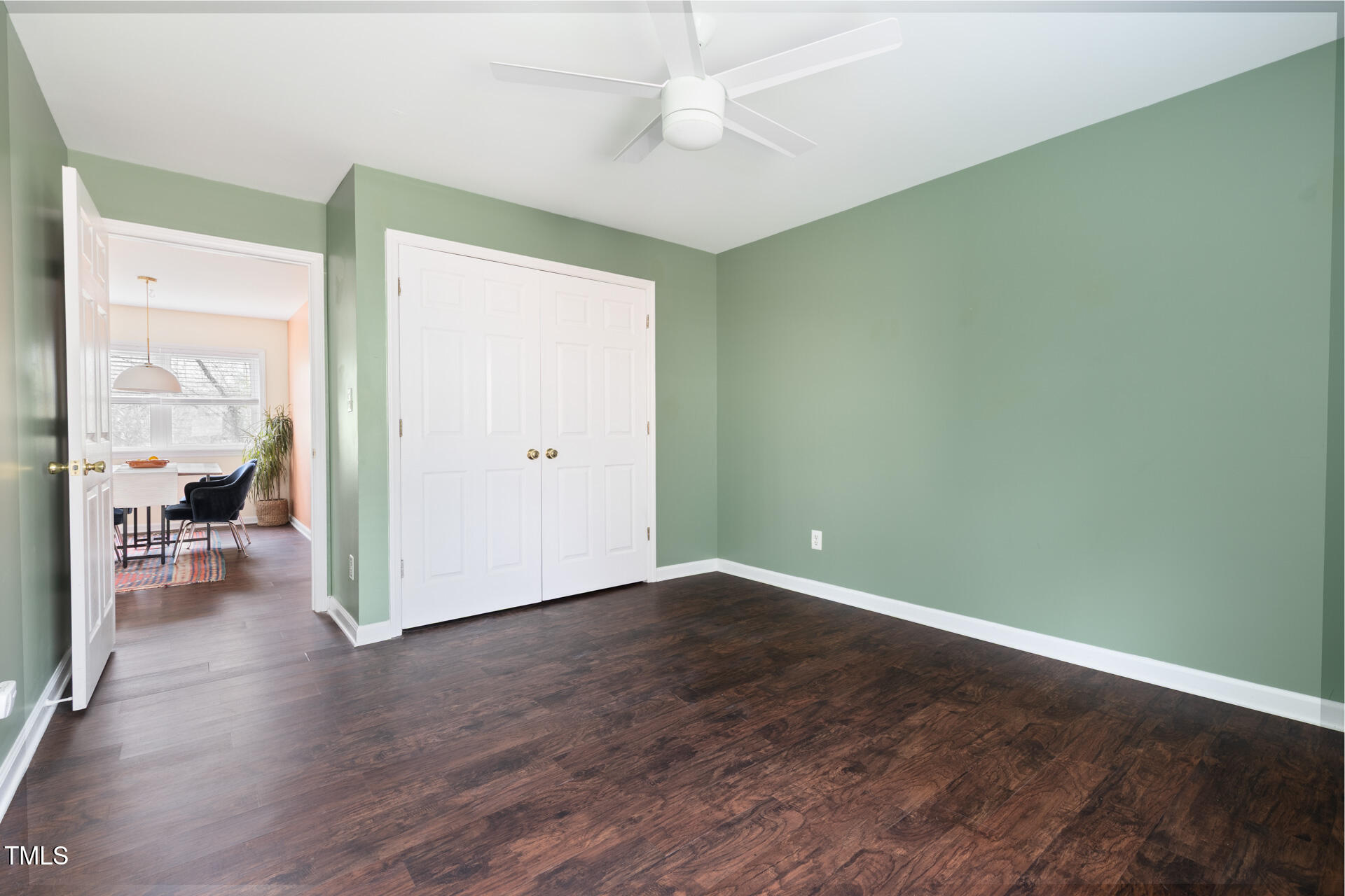 1234 Berkeley Street Durham, NC 27705 - Photo 43 of 46 an empty room with wooden floor and a ceiling fan
