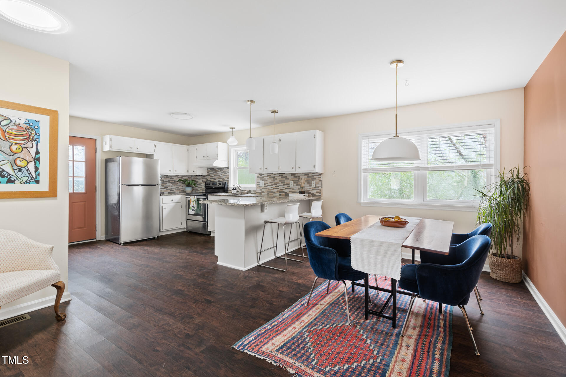 1234 Berkeley Street Durham, NC 27705 - Photo 4 of 46 a living room with stainless steel appliances kitchen island granite countertop furniture and a wooden floor