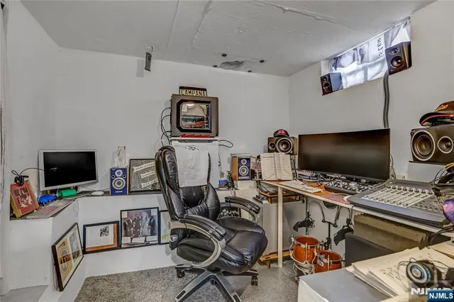 a view of a workspace with furniture and a flat screen tv