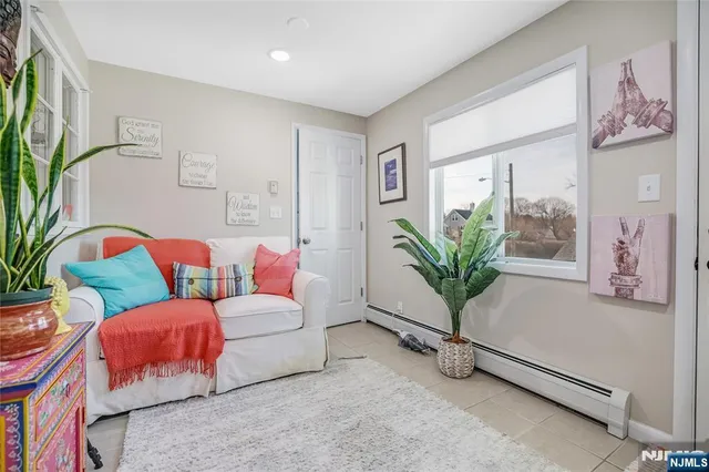 a living room with furniture lamp and flower pot