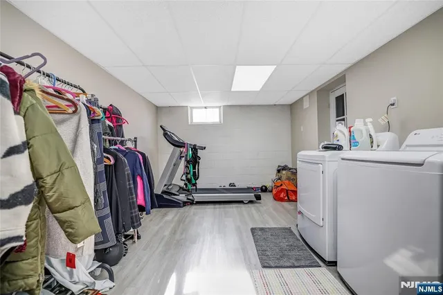 a view of walk in closet with clothes