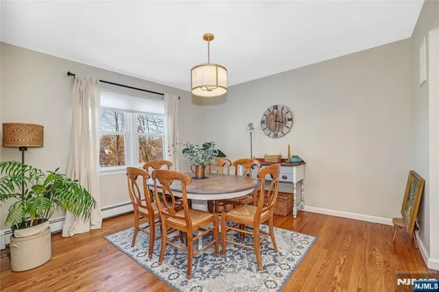 a view of a dining room with furniture wooden floor and a chandelier