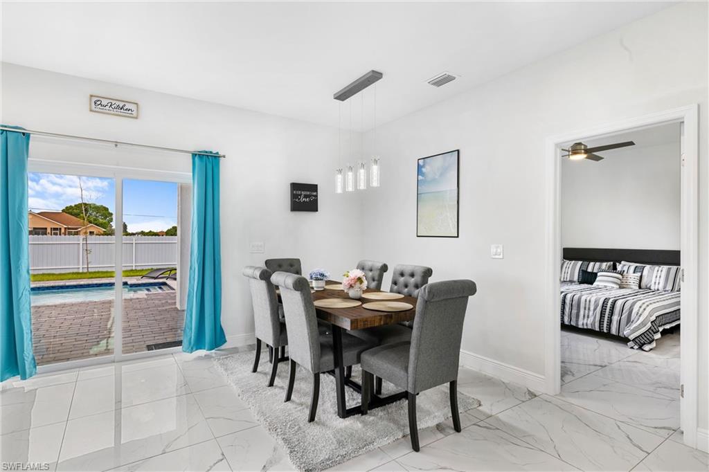 110 Nelson Road South Cape Coral, FL 33991 - Photo 14 of 27 a dining room with furniture and window