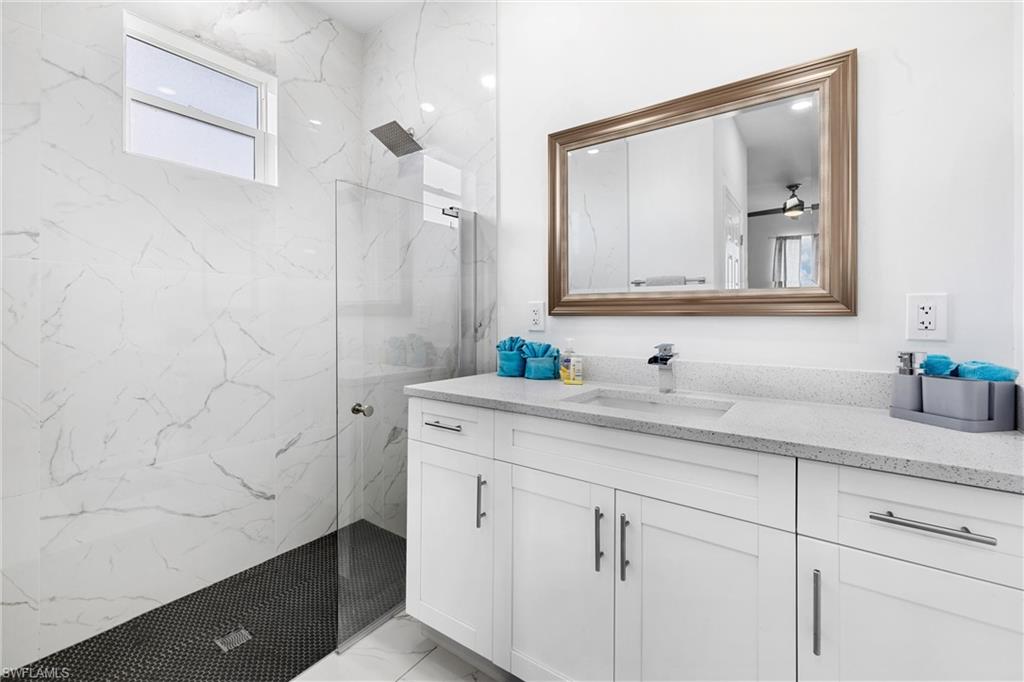 110 Nelson Road South Cape Coral, FL 33991 - Photo 18 of 27 a bathroom with a sink and a mirror