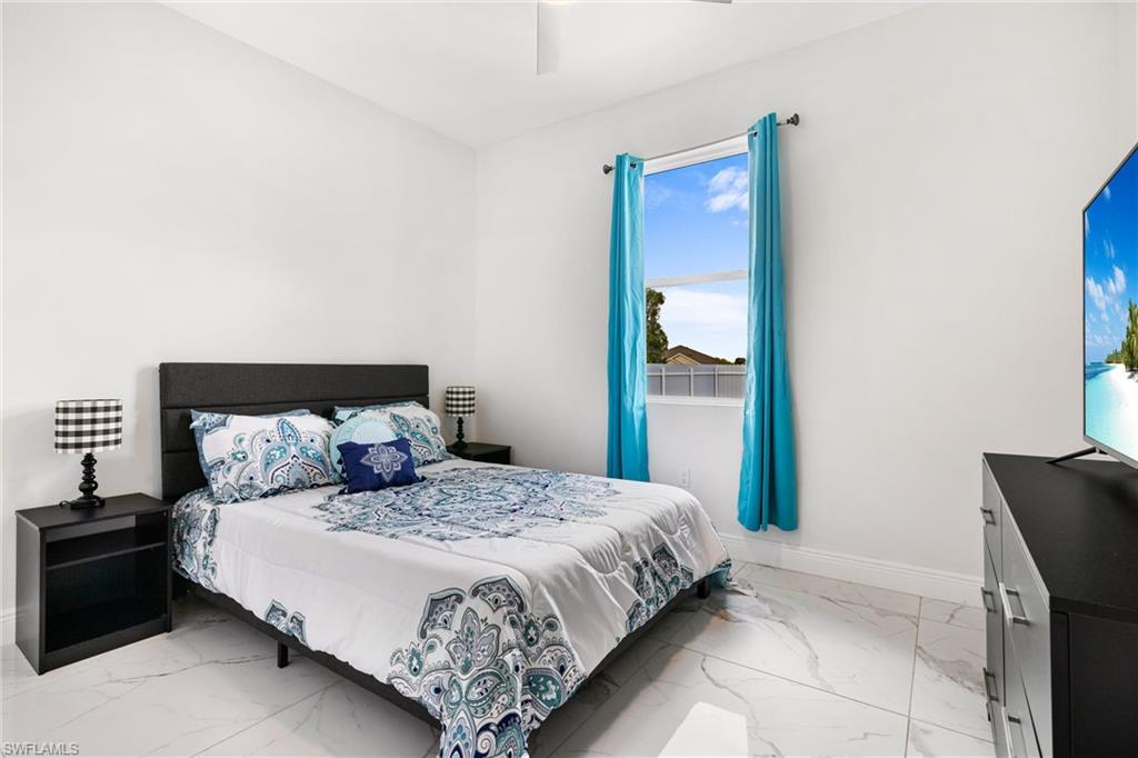 110 Nelson Road South Cape Coral, FL 33991 - Photo 20 of 27 a bedroom with a bed and window