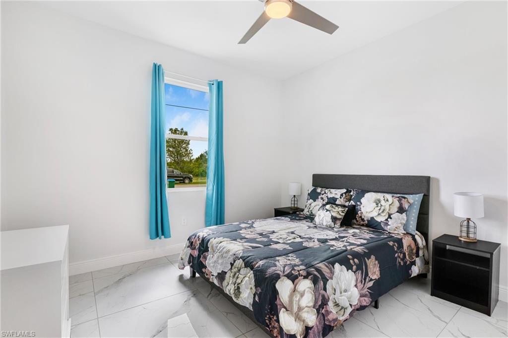 110 Nelson Road South Cape Coral, FL 33991 - Photo 21 of 27 a bedroom with a bed and a window