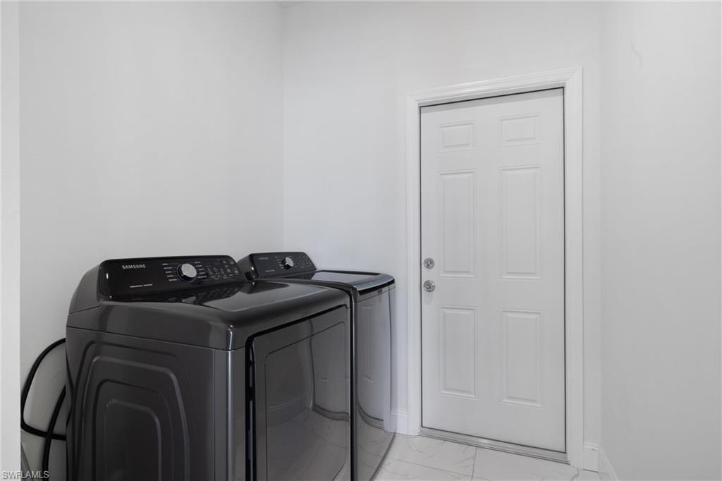110 Nelson Road South Cape Coral, FL 33991 - Photo 23 of 27 a utility room with dryer and washer