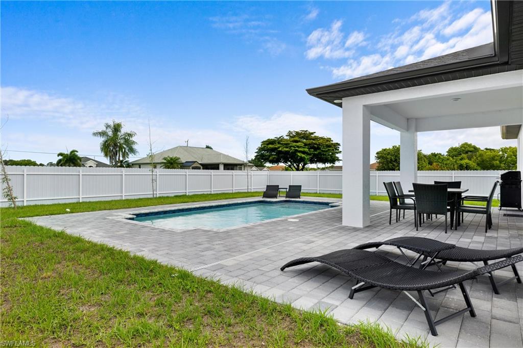 110 Nelson Road South Cape Coral, FL 33991 - Photo 25 of 27 a view of a backyard with swimming pool and sitting area
