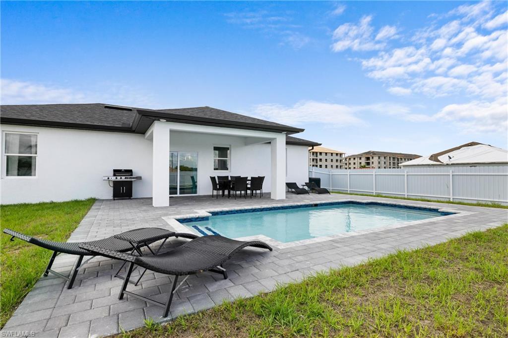 110 Nelson Road South Cape Coral, FL 33991 - Photo 27 of 27 a view of a swimming pool with lounge chair