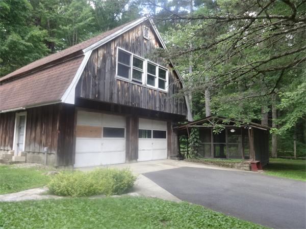867 Carpenter Road Athol, MA 01331 - Photo 2 of 7 a backyard of a house with large trees and plants