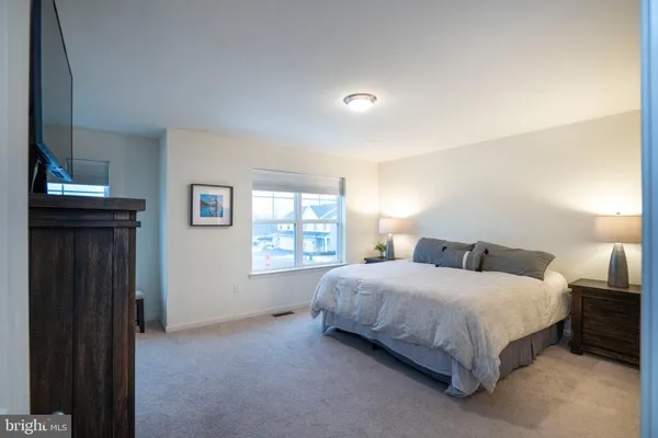 a view of walk in closet with clothes