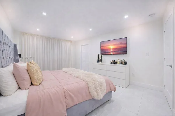 a bedroom with a bed and a mirror