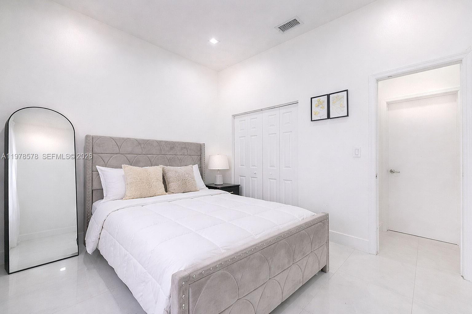 3502 Southwest 156th Court Miami, FL 33185 - Photo 12 of 47 a bedroom with a bed and a mirror