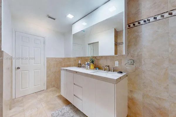 a bathroom with a shower and a sink