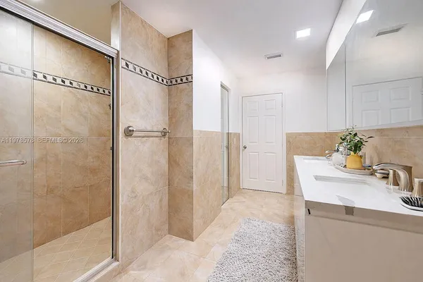 a spacious bathroom with a sink a toilet and shower