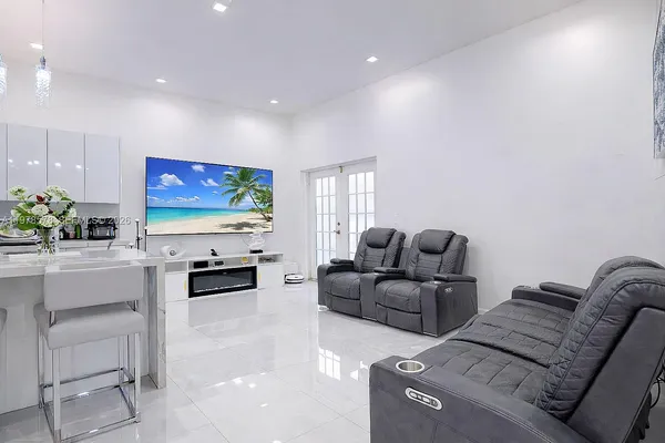 a kitchen with stainless steel appliances kitchen island granite countertop a sink and cabinets