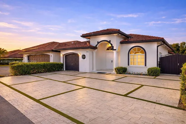 a front view of a house with garden