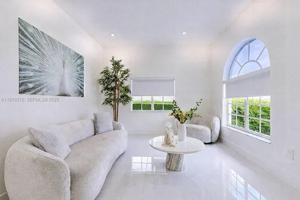 a large kitchen with stainless steel appliances kitchen island granite countertop a stove a sink and a microwave