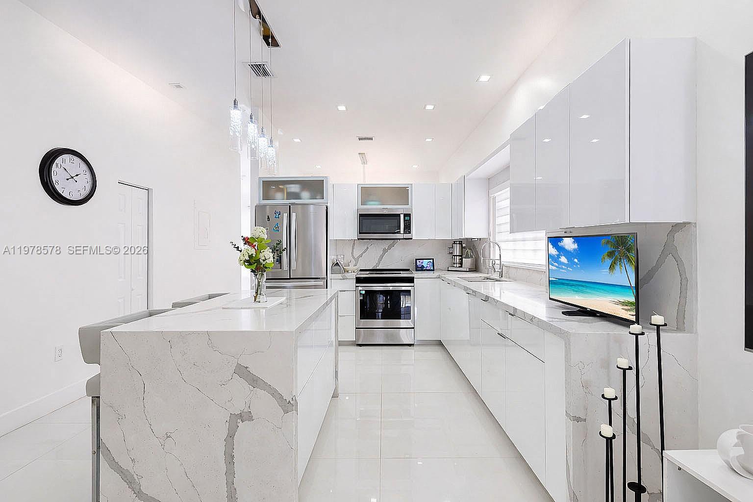 3502 Southwest 156th Court Miami, FL 33185 - Photo 22 of 47 a large kitchen with stainless steel appliances kitchen island granite countertop a stove a sink and a microwave