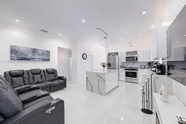 a kitchen with stainless steel appliances kitchen island granite countertop a sink and cabinets