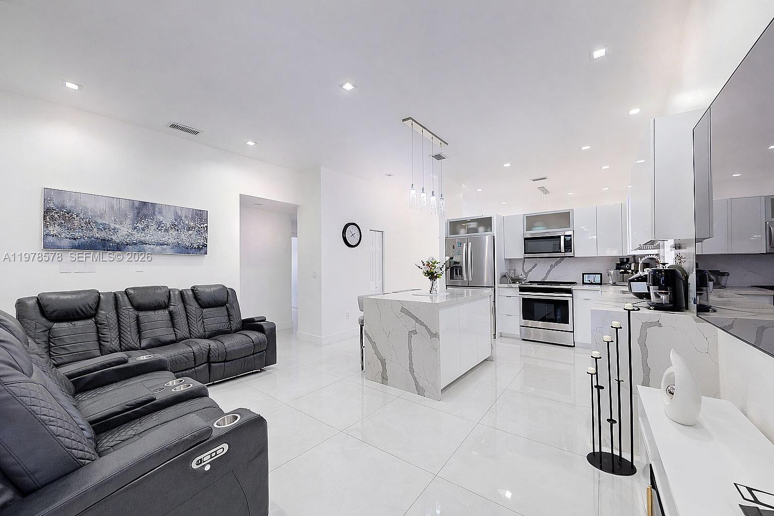 3502 Southwest 156th Court Miami, FL 33185 - Photo 29 of 47 a living room with furniture and kitchen view