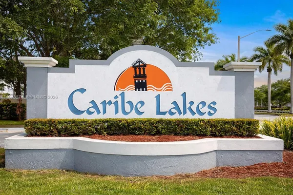 a view of swimming pool with a tub and trees in the background