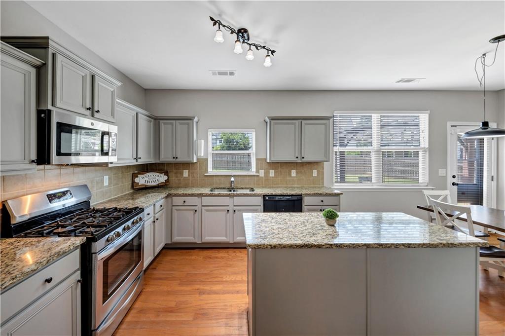 210 Creek View Lane Acworth, GA 30102 - Photo 11 of 48 a kitchen with granite countertop stainless steel appliances a sink stove and window