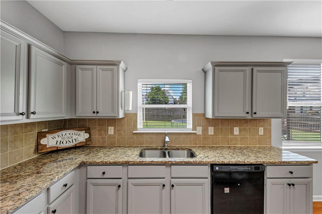 210 Creek View Lane Acworth, GA 30102 - Photo 14 of 48 a kitchen with granite countertop stainless steel appliances white cabinets granite counter tops and a window
