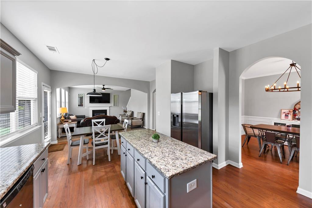 210 Creek View Lane Acworth, GA 30102 - Photo 15 of 48 a kitchen with stainless steel appliances kitchen island granite countertop a table chairs and a stove