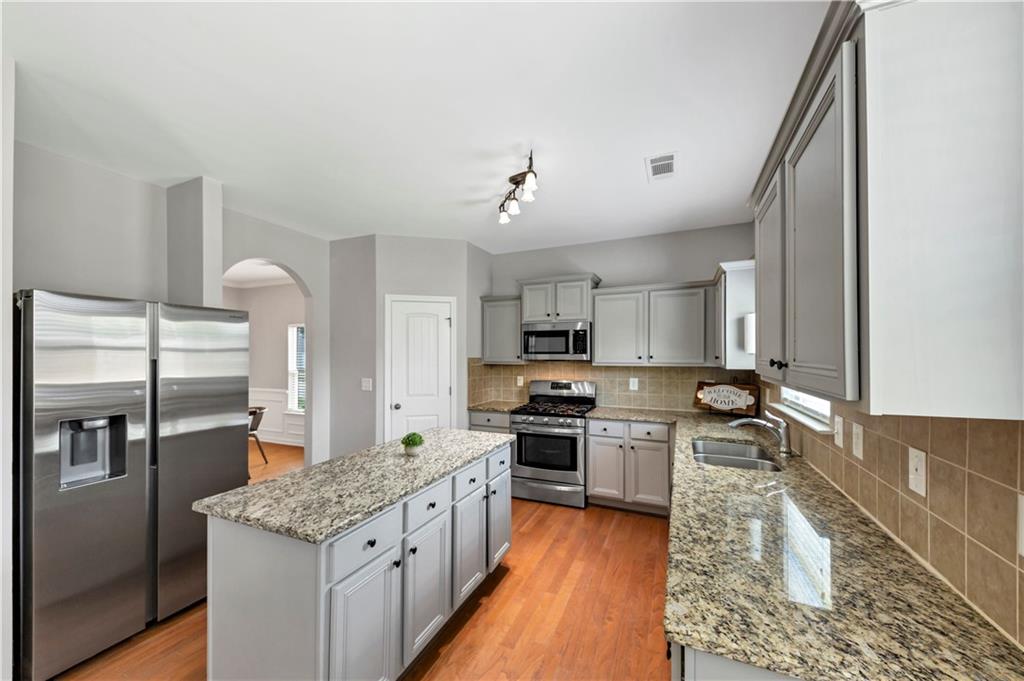210 Creek View Lane Acworth, GA 30102 - Photo 16 of 48 a kitchen with stainless steel appliances granite countertop a sink stove and refrigerator
