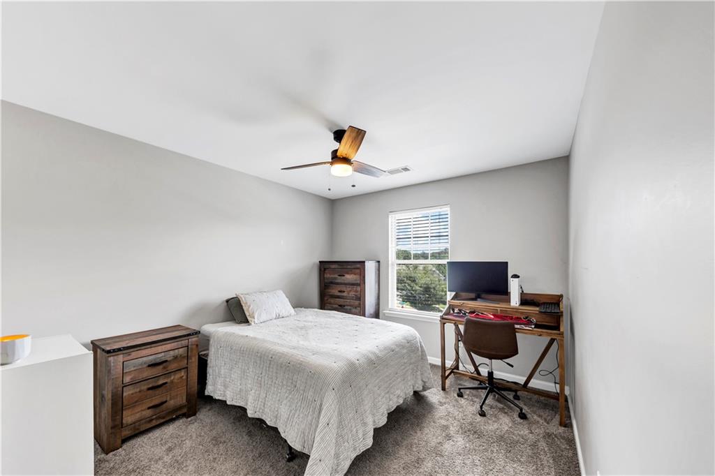 210 Creek View Lane Acworth, GA 30102 - Photo 24 of 48 a bedroom with a bed and a chandelier