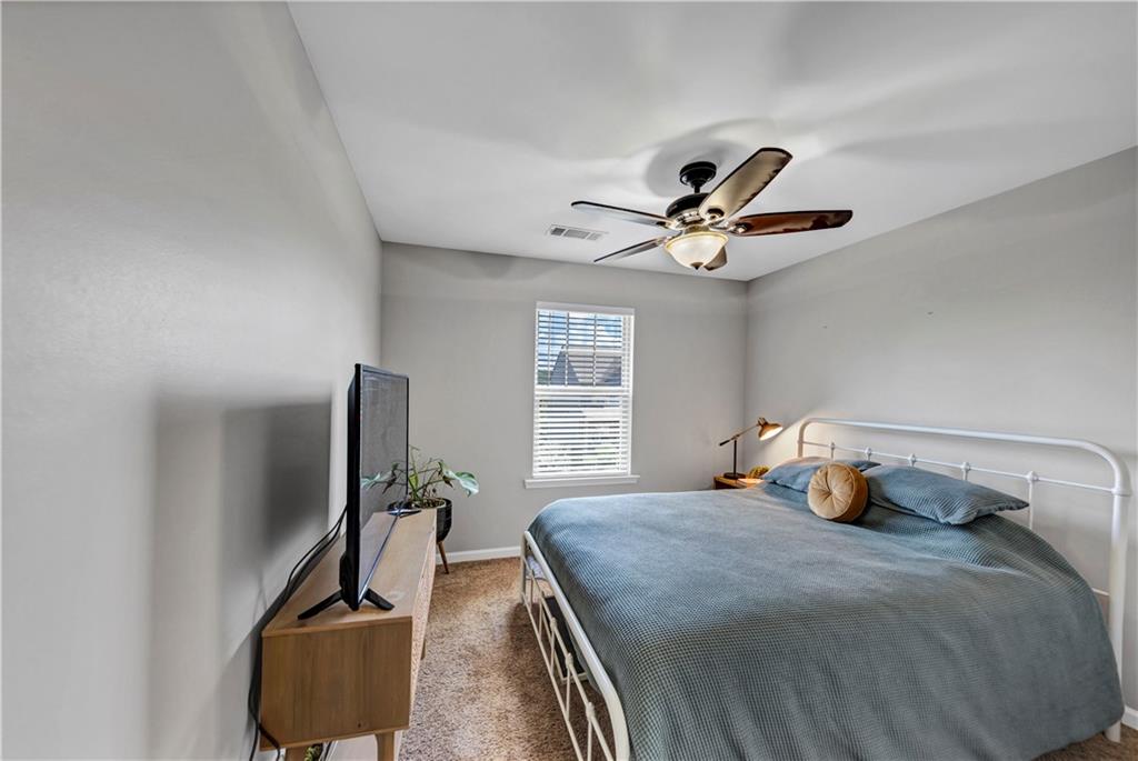 210 Creek View Lane Acworth, GA 30102 - Photo 26 of 48 a bedroom with a bed and a chandelier