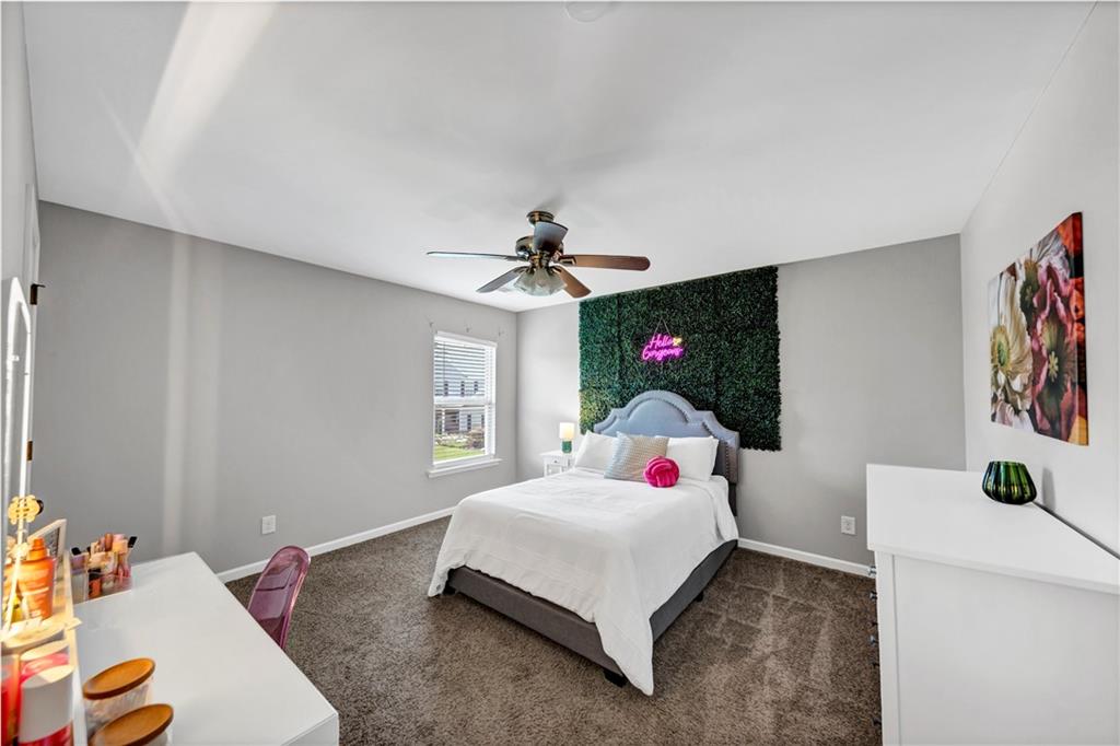 210 Creek View Lane Acworth, GA 30102 - Photo 28 of 48 a bed room with a bed a couch and a window